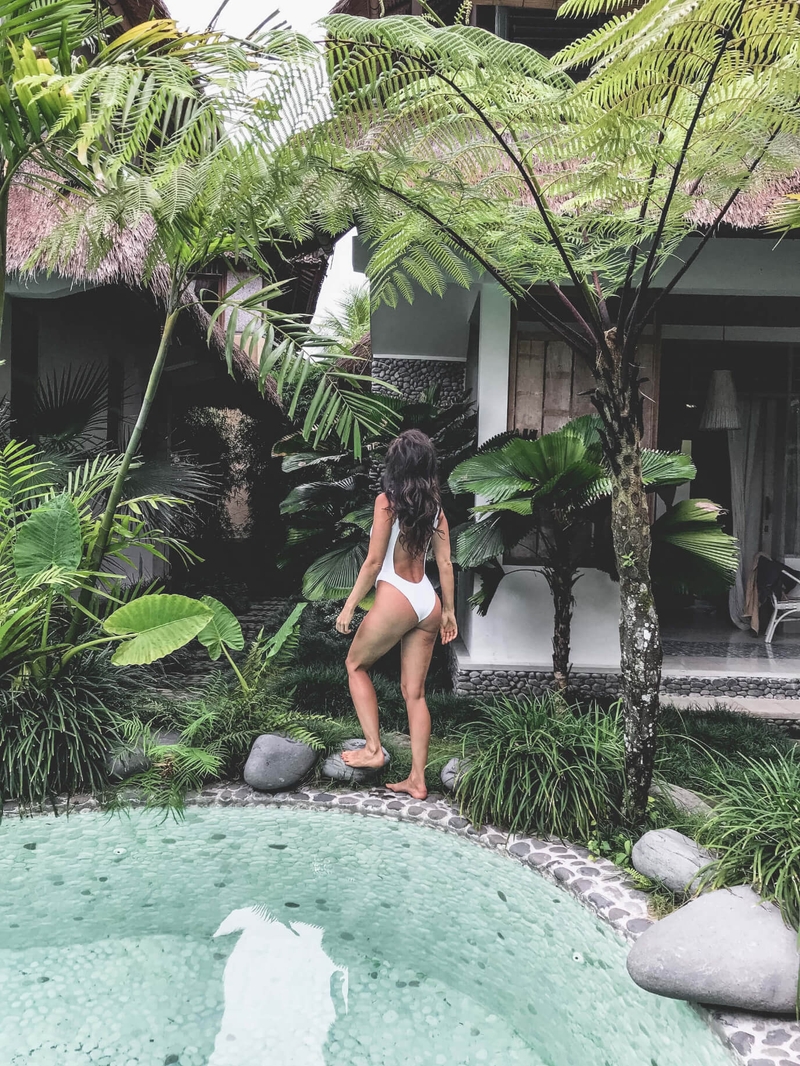 Woman in white bathing suit by the pool